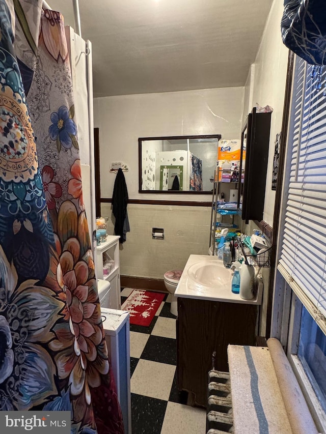 bathroom featuring vanity and toilet