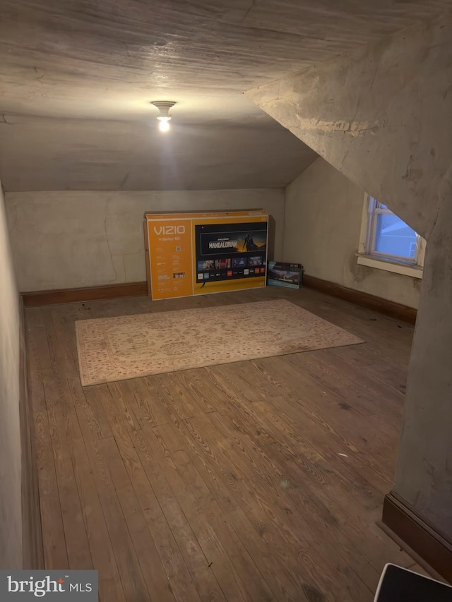 bonus room with wood-type flooring and lofted ceiling