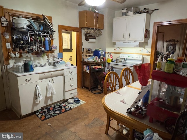 kitchen with white cabinetry, sink, and white electric stove