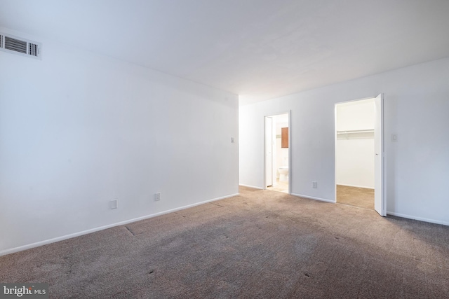 spare room featuring light carpet