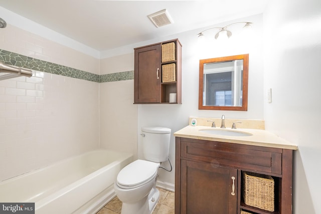 full bathroom with tiled shower / bath, tile patterned flooring, vanity, and toilet