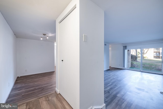 hallway with dark wood-type flooring