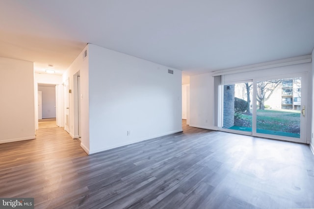 spare room featuring dark hardwood / wood-style floors