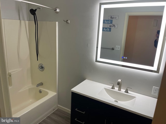 bathroom featuring shower / tub combination, vanity, and hardwood / wood-style floors