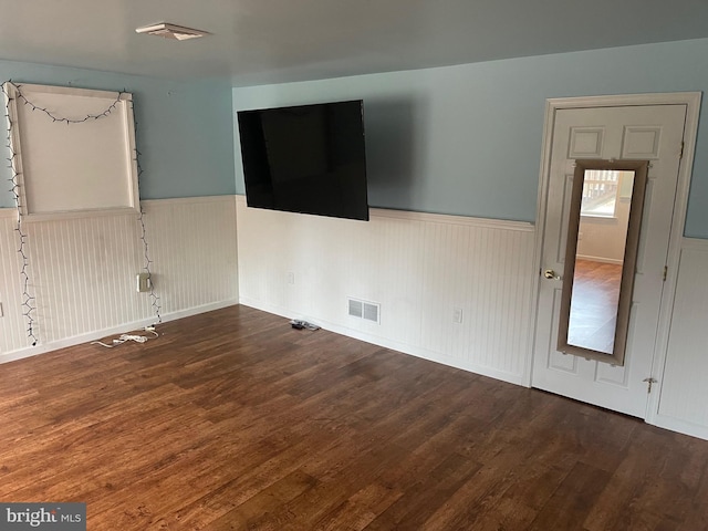 unfurnished room featuring dark wood-type flooring