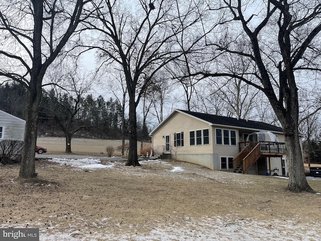 snow covered property featuring a wooden deck