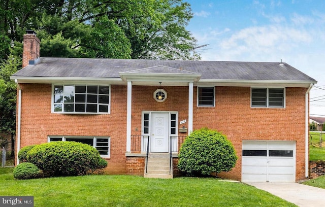 bi-level home with a front yard and a garage