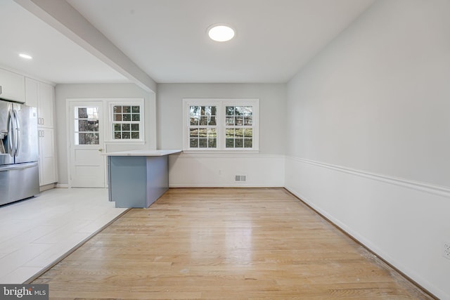 unfurnished dining area with light wood-type flooring