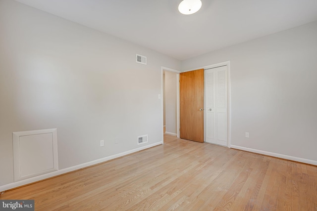 unfurnished bedroom with a closet and light hardwood / wood-style flooring