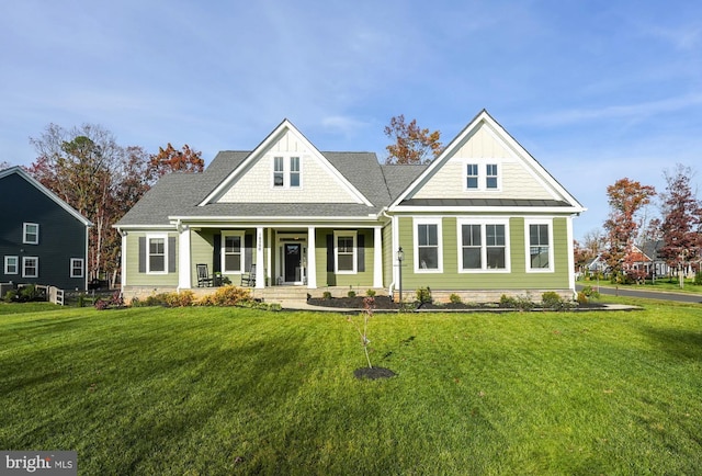 craftsman-style house featuring a porch and a front yard