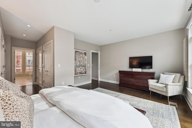 bedroom with dark hardwood / wood-style flooring