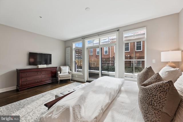 bedroom featuring dark hardwood / wood-style floors and access to outside