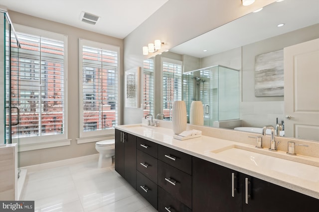 bathroom featuring toilet, tile patterned floors, an enclosed shower, and vanity