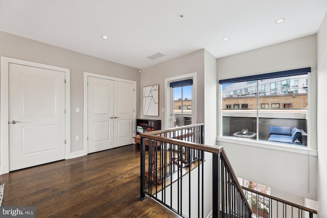 hall with dark hardwood / wood-style floors