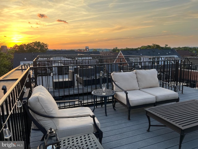 deck at dusk with an outdoor living space