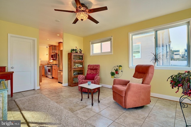 living area featuring ceiling fan and light tile patterned flooring