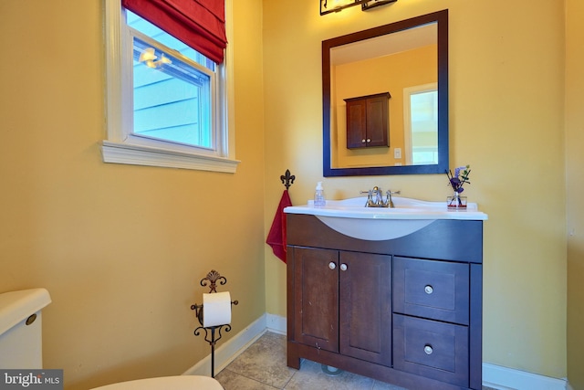 bathroom featuring tile patterned flooring, vanity, and toilet