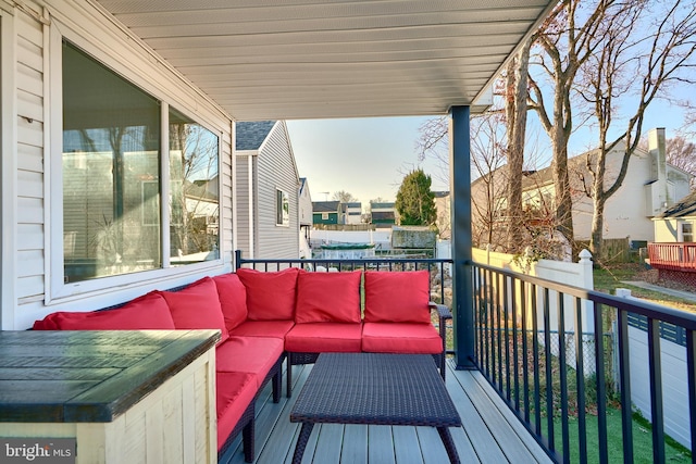 wooden terrace featuring an outdoor living space