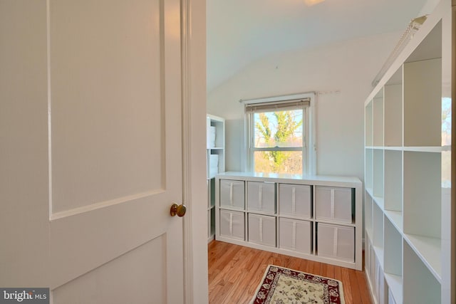 interior space featuring light hardwood / wood-style floors and vaulted ceiling