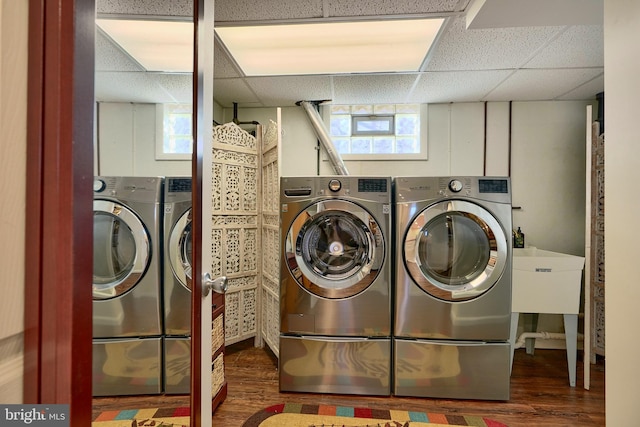 washroom with independent washer and dryer and dark wood-type flooring