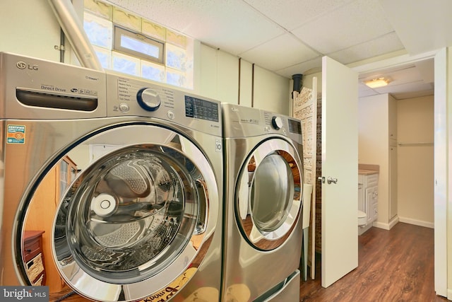 laundry room featuring dark wood-type flooring and washing machine and clothes dryer