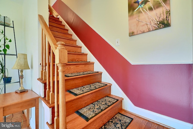 stairway featuring wood-type flooring