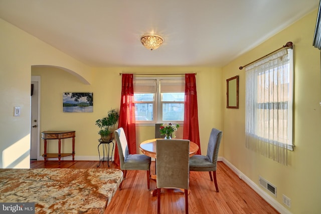 dining space featuring plenty of natural light and light hardwood / wood-style floors