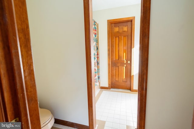 hall featuring light tile patterned floors