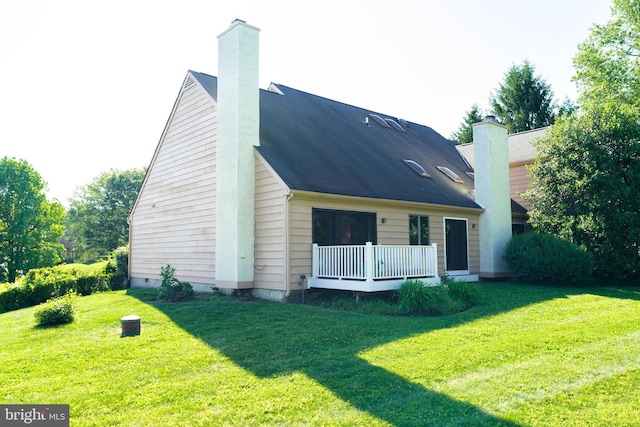 back of property featuring a lawn