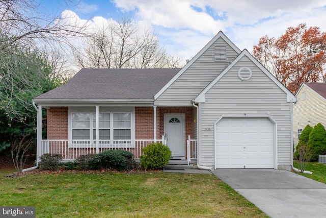 view of front of property with a front yard and a garage