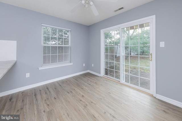 unfurnished dining area with light hardwood / wood-style floors, plenty of natural light, and ceiling fan