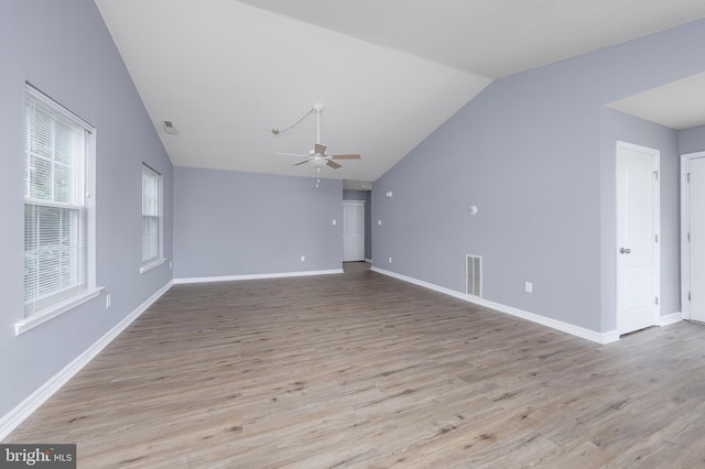 unfurnished living room featuring ceiling fan, light wood-type flooring, and vaulted ceiling