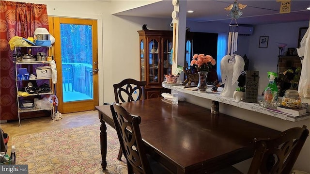 dining room featuring a wall mounted AC