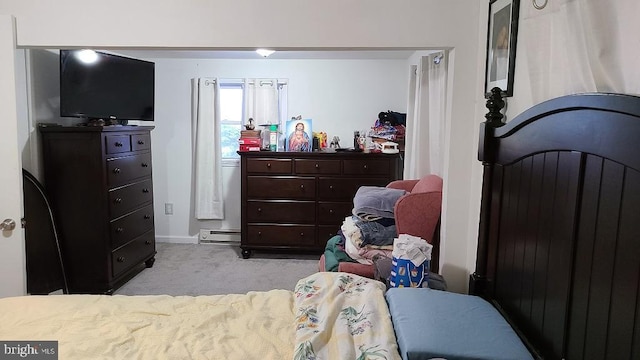 carpeted bedroom featuring a baseboard heating unit