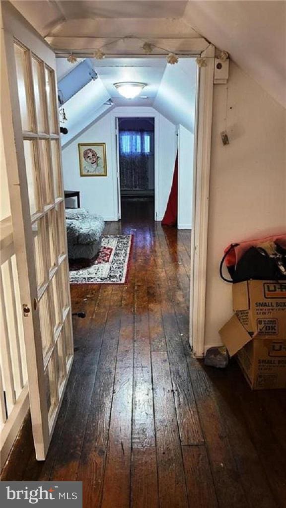 bonus room with lofted ceiling and dark wood-type flooring