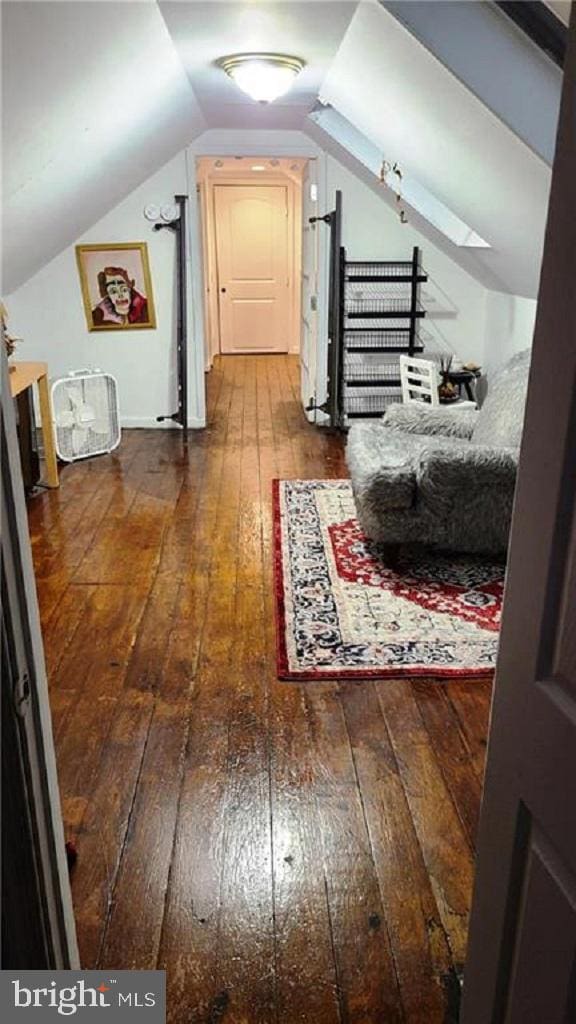 bonus room featuring lofted ceiling and hardwood / wood-style flooring