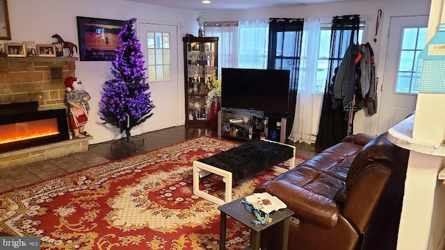 living room featuring a wealth of natural light and a fireplace