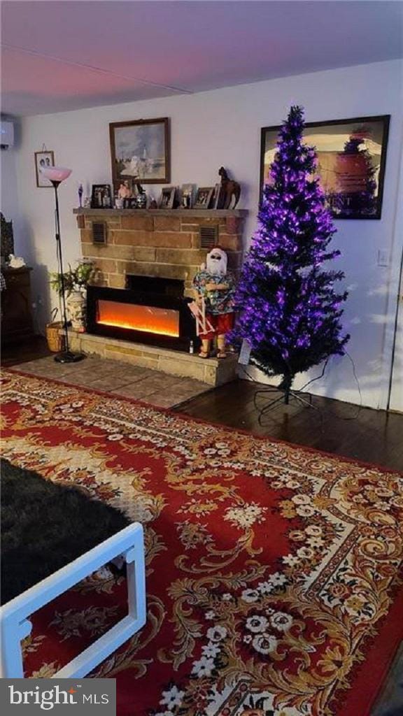 living room featuring a stone fireplace