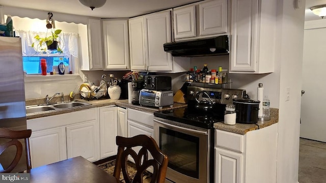 kitchen with white cabinets, electric range, and sink