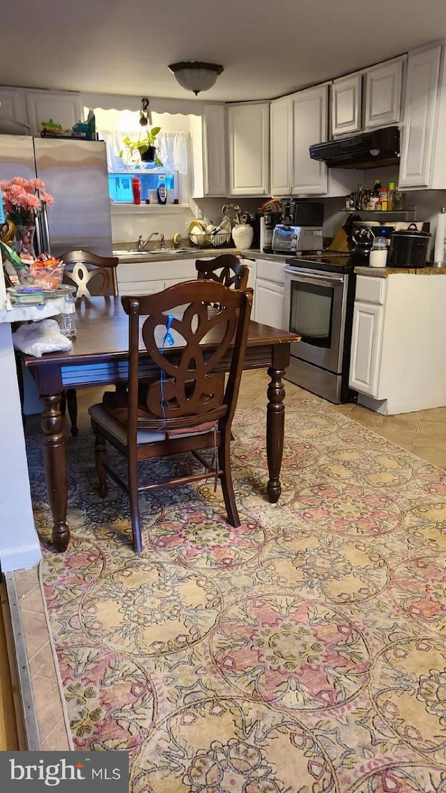 dining room with light tile patterned flooring and sink