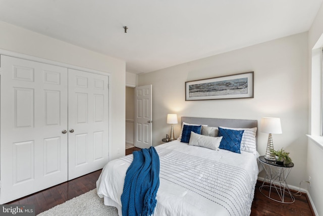 bedroom featuring wood finished floors, a closet, and baseboards