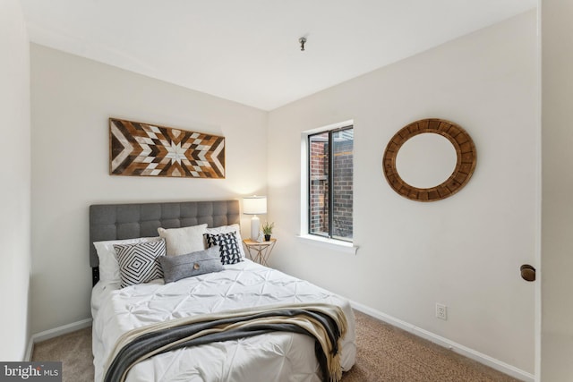 bedroom featuring baseboards and carpet