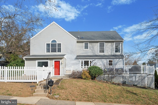 view of front facade featuring a wooden deck and a front lawn