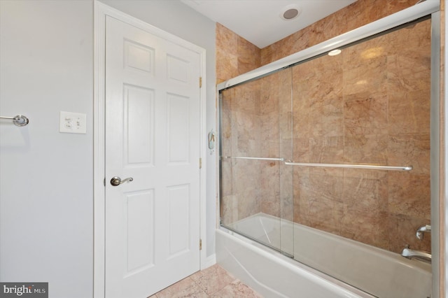 bathroom with shower / bath combination with glass door and tile patterned floors