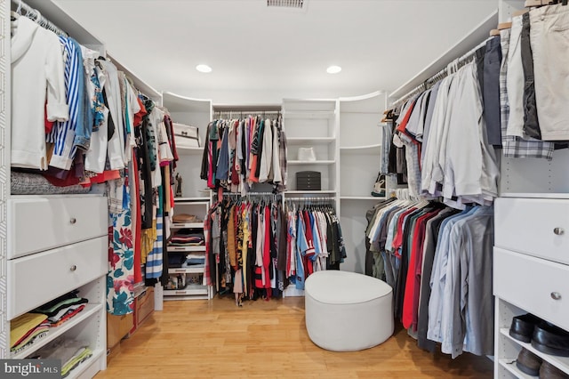 spacious closet featuring light hardwood / wood-style floors