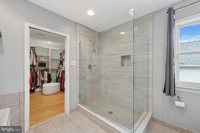 bathroom featuring hardwood / wood-style floors and a shower with shower door