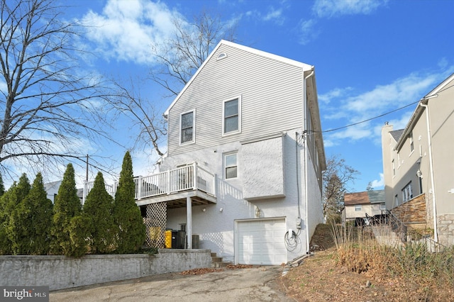 exterior space featuring a garage and a balcony