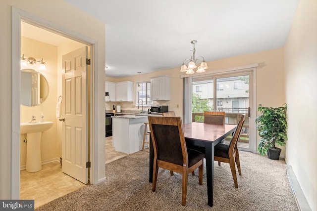 dining space with light carpet, sink, and a notable chandelier