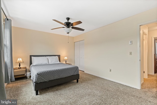 carpeted bedroom with a closet and ceiling fan