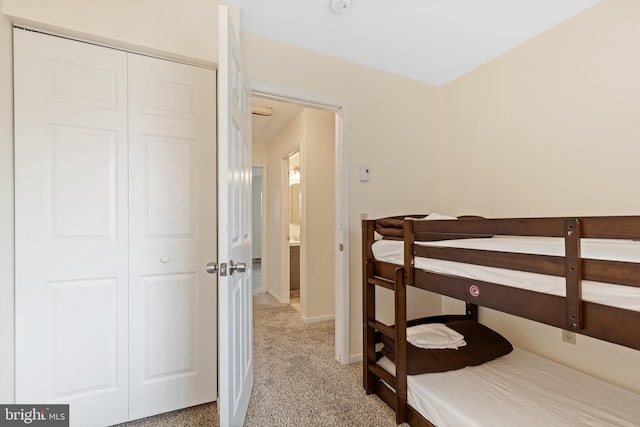 carpeted bedroom featuring a closet